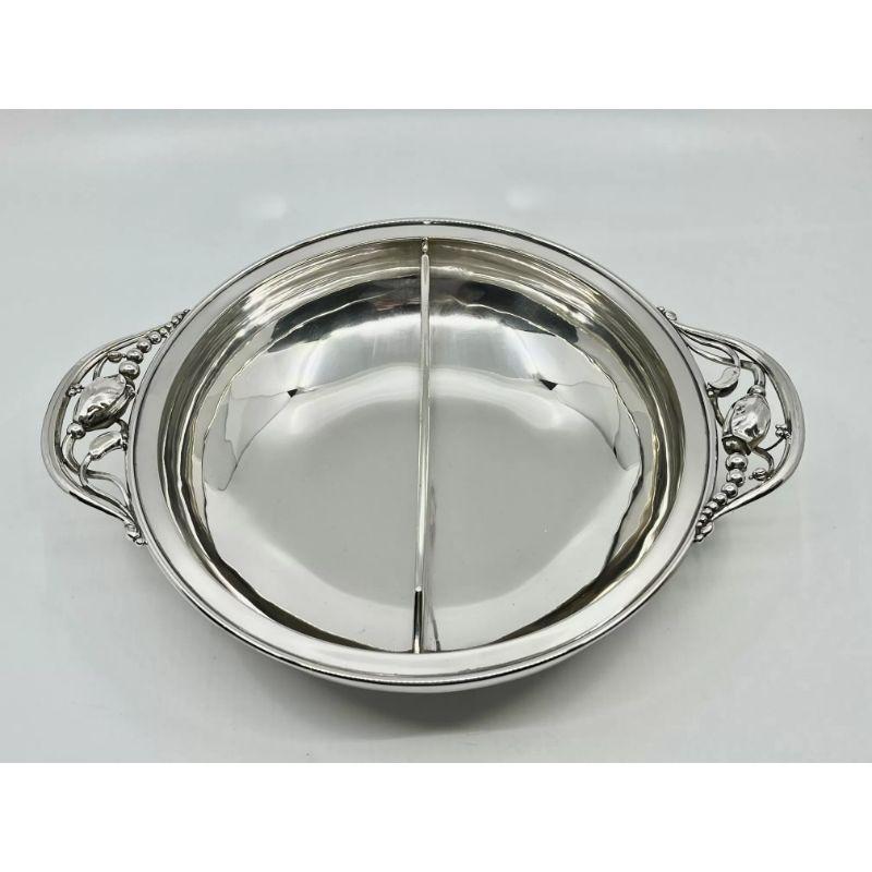 A vintage sterling silver Georg Jensen Blossom/Magnolia serving bowl, with a fixed central divider, design #2D by Georg Jensen from 1904.

Additional information:
Material: Sterling silver
Styles: Art Nouveau
Hallmarks: Vintage Georg Jensen hallmark