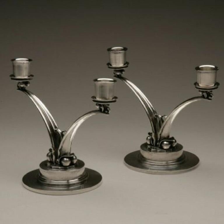 Georg Jensen

Georg Jensen sterling silver candelabra by Harald Nielsen, No. 278

Sterling silver pair of Mid-Century Modern two-light candelabra designed by Harald Nielsen with characteristic nautical pearl and wave design aspects. Post-1945,