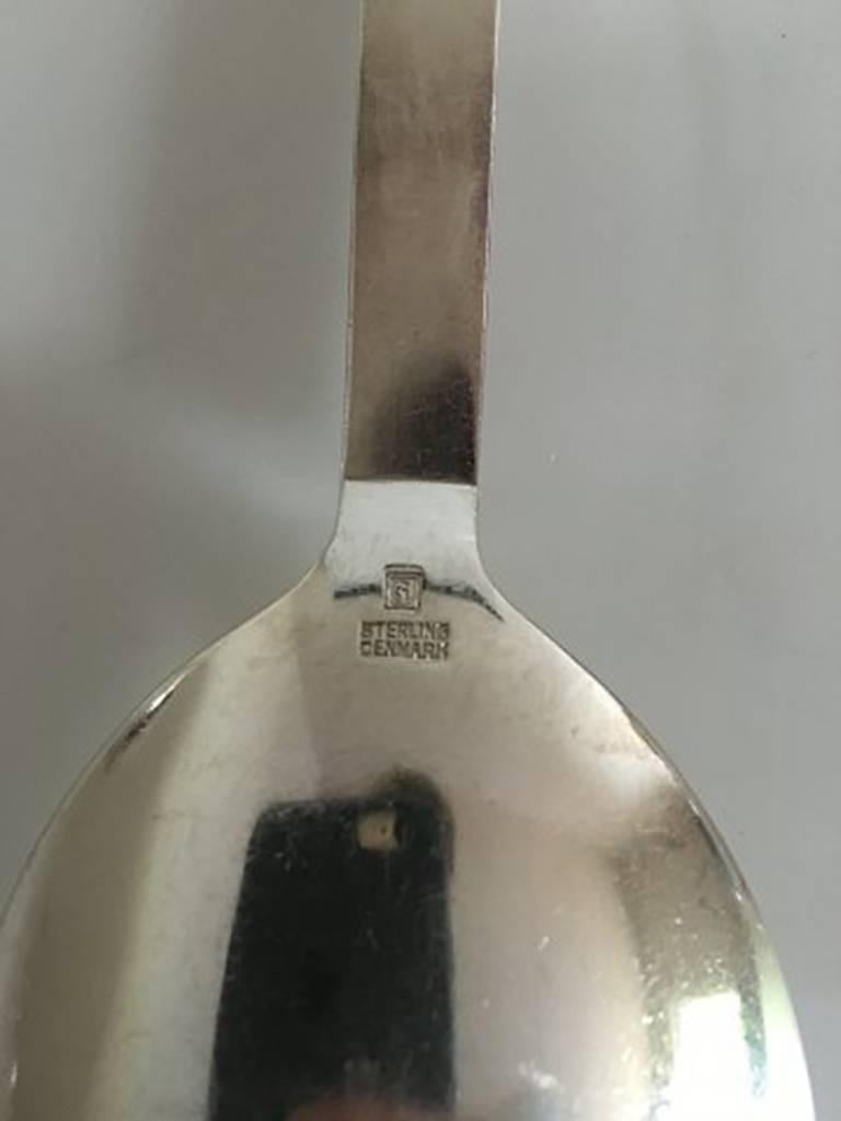Georg Jensen sterling silver parallel serving spoon, medium #113. 2 with old marks and one with new marks. Measures: 23.3 cm /9 9/64 in. Design Oscar Gundelach-Petersen 1931.