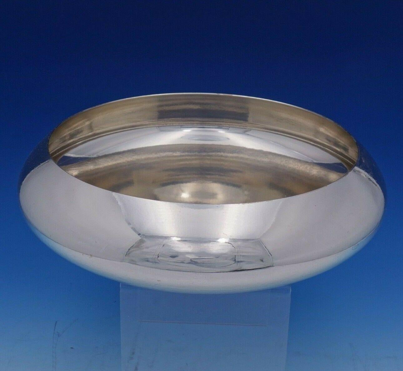 Georg Jensen

Stunning Georg Jensen sterling silver modernist presentation bowl. The center is marked 1866-1966 with an applied medallion with crown and three stars. The piece measures: 11