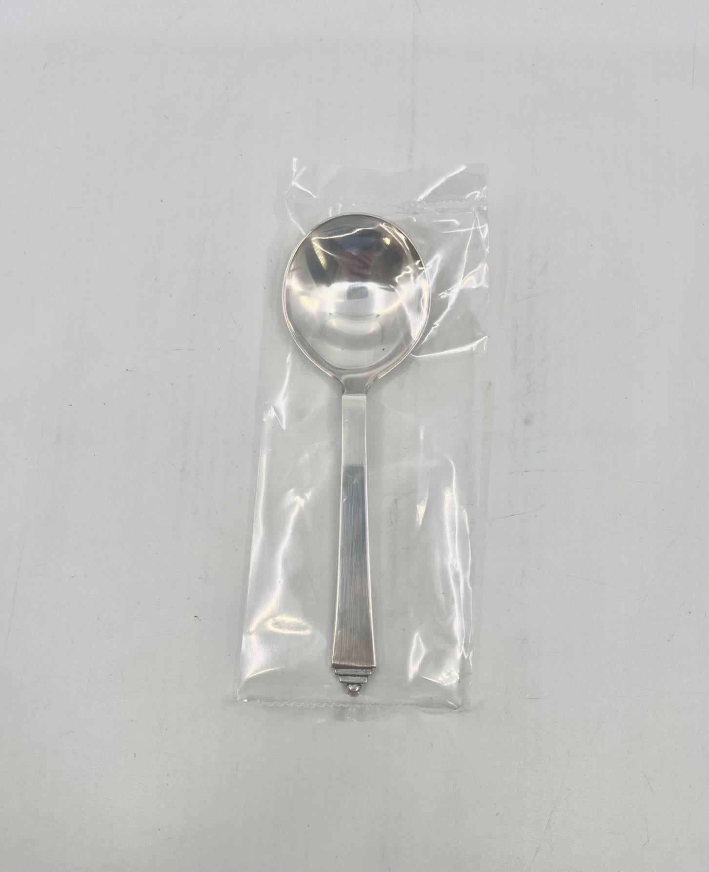 A sterling silver Georg Jensen round soup spoon, item #051 in the Pyramid pattern, design #15 by Harald Nielsen from 1926. These spoons are no longer produced.

Additional information:
Material: Sterling silver
Styles: Art Deco
Hallmarks: With Georg