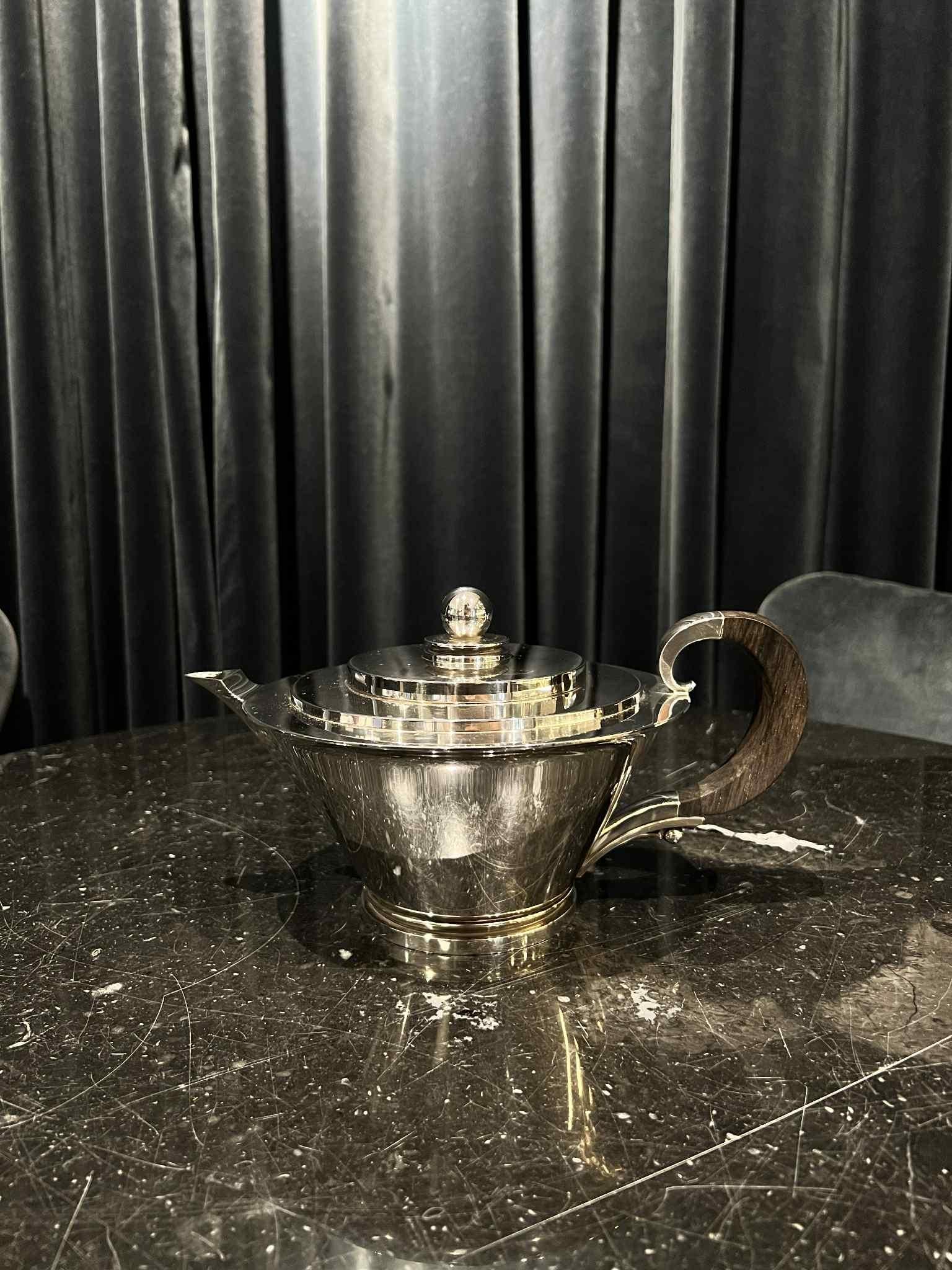A large sterling silver Georg Jensen Pyramid art deco teapot with an ebony handle, design #600B by Harald Nielsen from 1930. Inspired by the 1922 discovery of Tutankhamun’s tomb by Howard Carter, the Pyramid pattern embodies the Egyptomania of the
