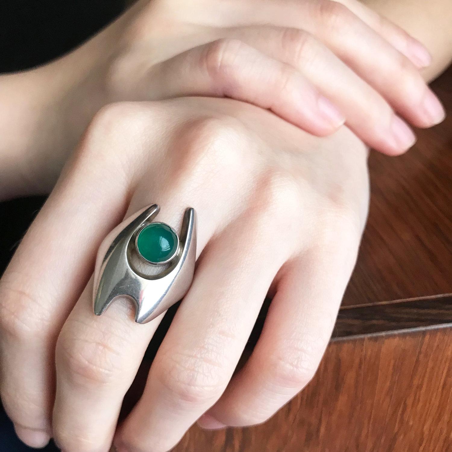Georg Jensen Sterling Silver Ring by Henning Koppel No 139.
Bright Green Agate.  Size 8

Designer: Georg Jensen
Maker: Georg Jensen
Design #: 139
Circa: Post 1970
Dimensions: Size 8
Country of Origin: Denmark

Complimentary gift box included with