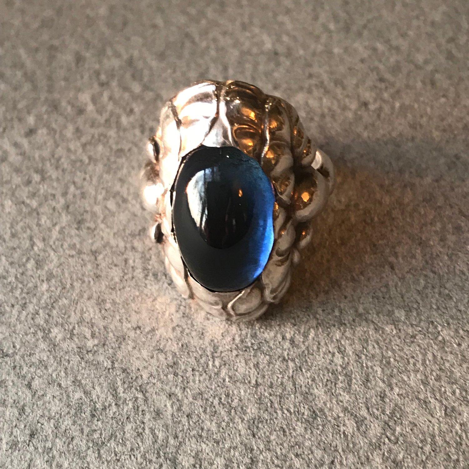 Rare Georg Jensen Sterling Silver ring No. 11 with Synthetic Sapphire.
Size 6.75 

 Superb details and excellent condition.

Designer: Georg Jensen 
Maker: Georg Jensen 
Design #: 11 
Circa: Post 1945
Dimensions: 0.75'' x 1'' ; Size 6.75 
Country of