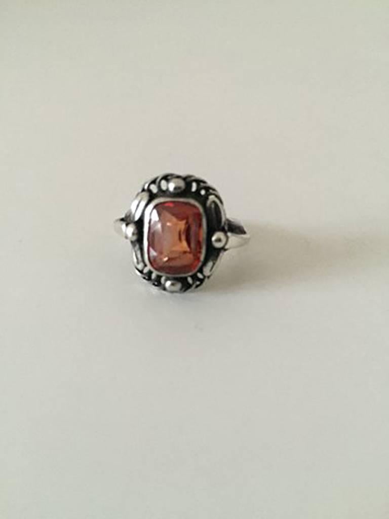 Georg Jensen Sterling Silver Ring with Orange Synthetic Sapphire No 10. With very worn marks, but it can be seen it is from 1933-1944. Ring Size 50 / US 5 1/4. Weighs 4 g / 0.14 oz.