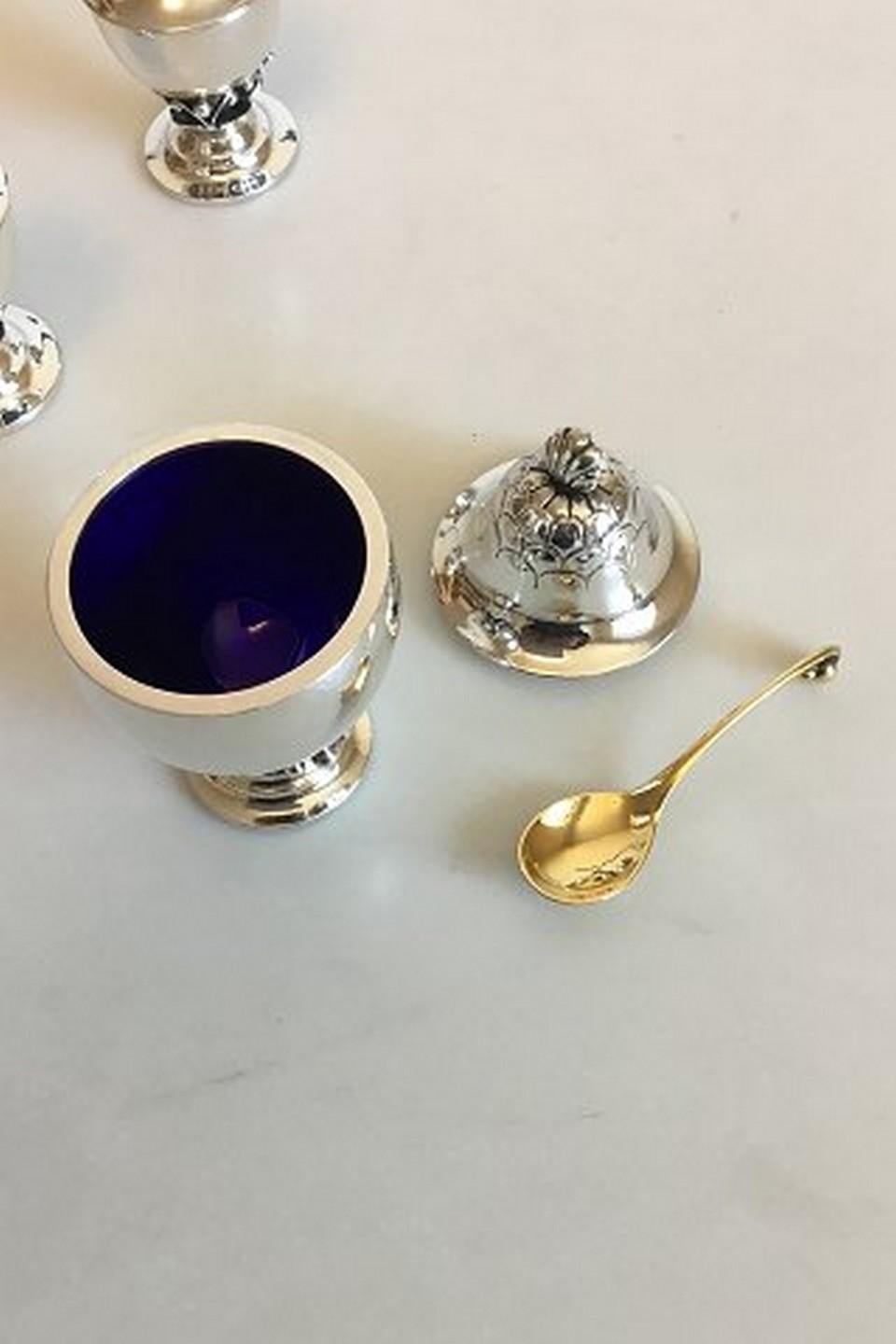 Georg Jensen sterling silver salt and pepper shakers and mustard jar with gilded spoon No 235.
Measures salt and pepper: 7.2 cm / 2 53/64 in. Mustard: 9 cm / 3 35/64 in. Weighs combined 185 g / 6.55 oz.
Item no.: 374215.
  