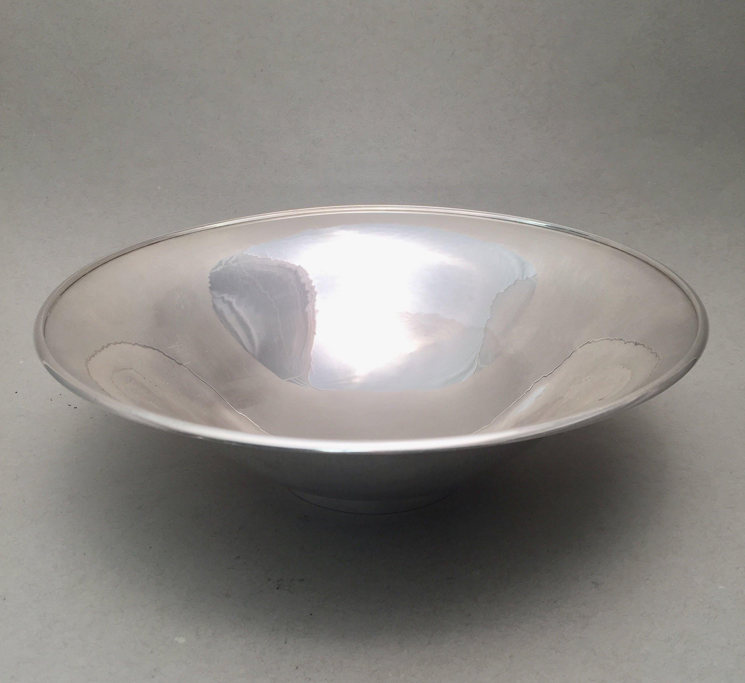 Sterling silver serving bowl in pattern 430B by Danish maker Georg Jensen. Designed in a classic and simple design, standing on base. Measuring 3 inches tall and 9 1/4 inches in diameter. Weighing 12.9 troy ounces. Bearing hallmarks as shown.