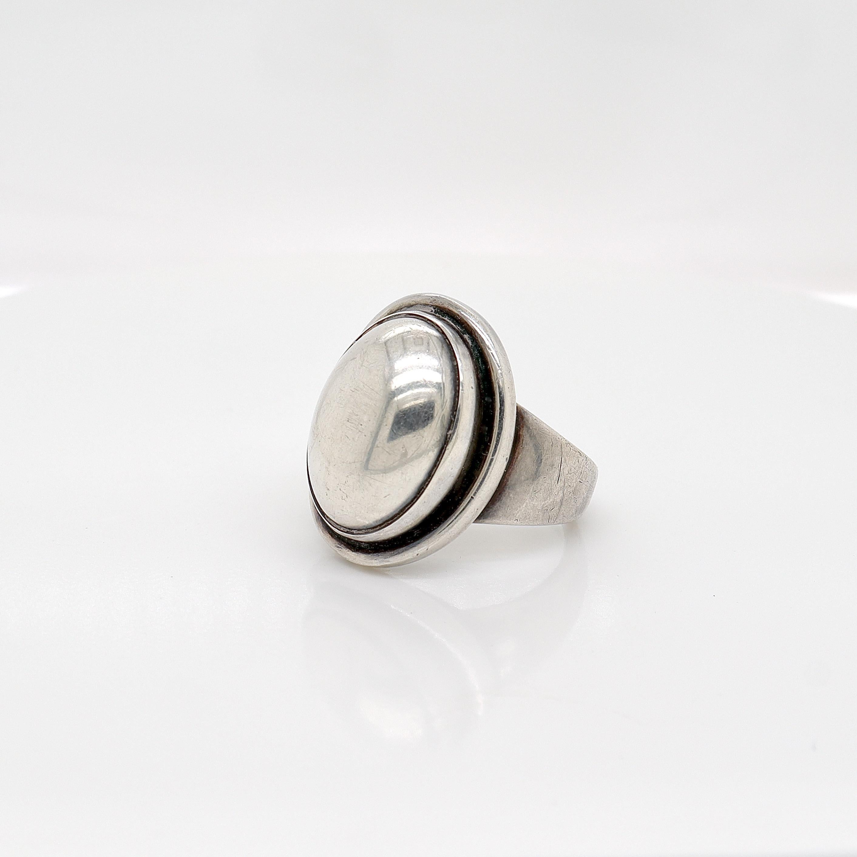 A fine sterling silver signet ring.

By Georg Jensen.

Model no. 46A

Designed by Harald Nielsen.

Simply a wonderful ring from one of Denmark's premier silversmiths!

Date:
20th Century, post-1945

Overall Condition:
It is in overall good,