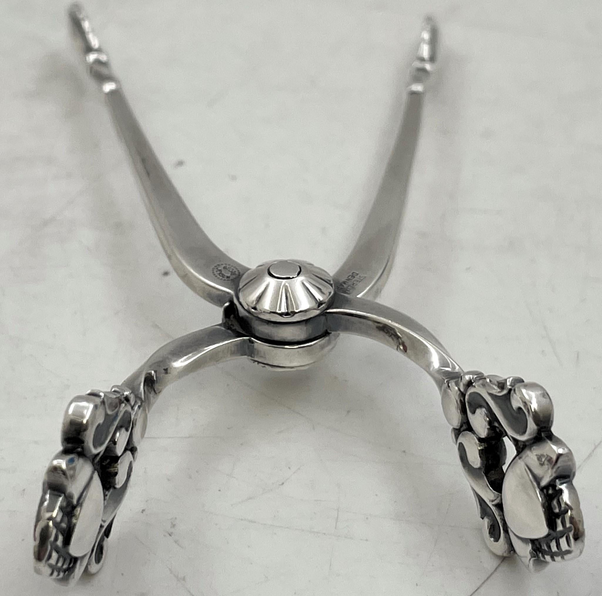 Georg Jensen sterling silver sugar tongs, in the celebrated Acorn pattern, measuring 3 3/4'' in length by 1 2/3'' in depth, and bearing hallmarks as shown. 

Danish silversmith Georg Jensen (1866-1935) set up his own silver business in 1904 in