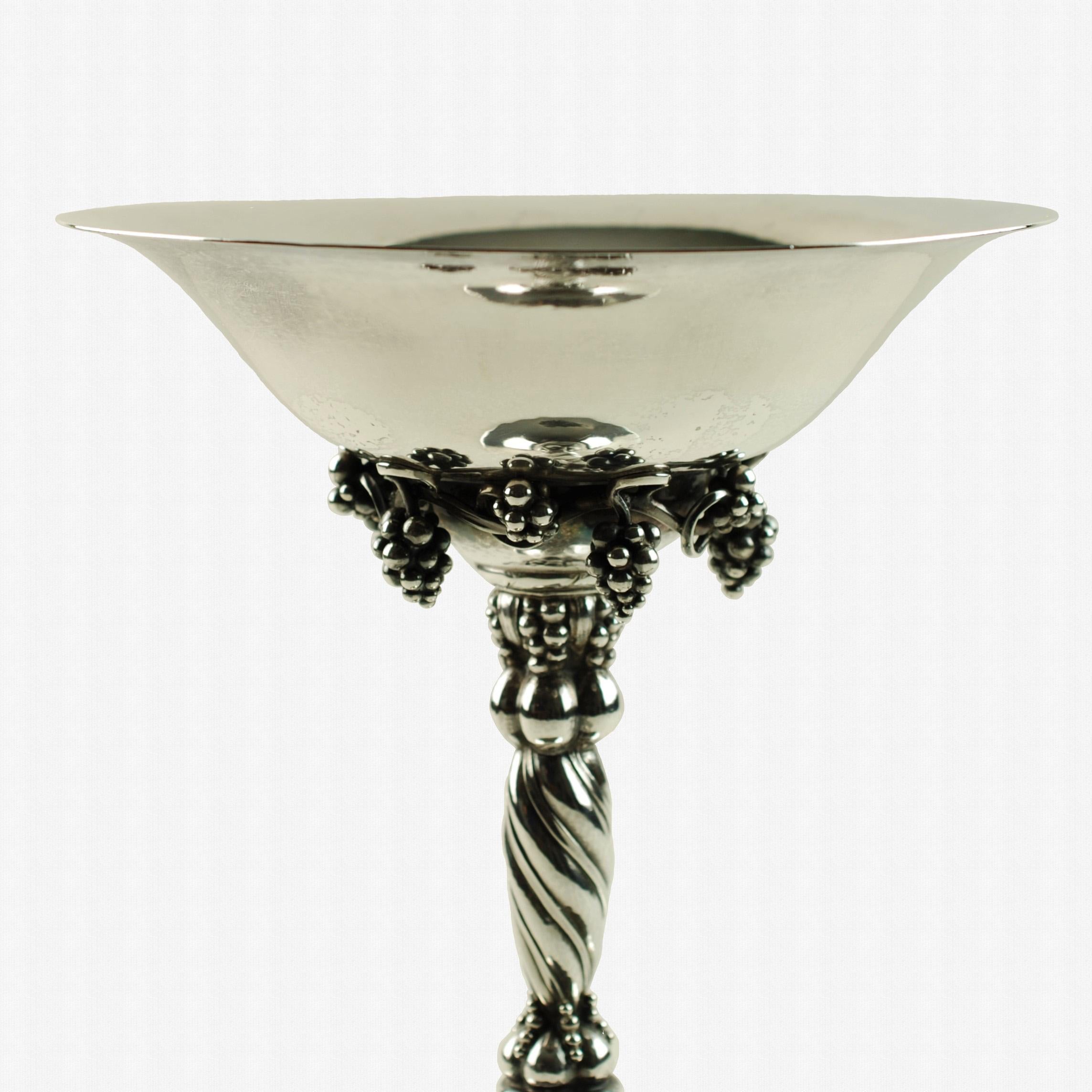 Vintage Georg Jensen sterling silver tazza compote with grape motif. This fabulous Georg Jensen sterling silver tazza features Jensen's iconic grape motif, a celebrated range of pieces which were inspired by the Art Nouveau aesthetic coupled with