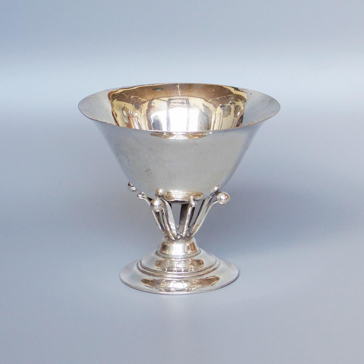 A Georg Jensen sterling silver, footed Tazza bowl designed by Johan Rohde. Marked Georg Jensen. 

Dimensions: H 12.5cm, D 14.5cm

Origin: Danish

Date: 1925-1932

Item number: 288207.