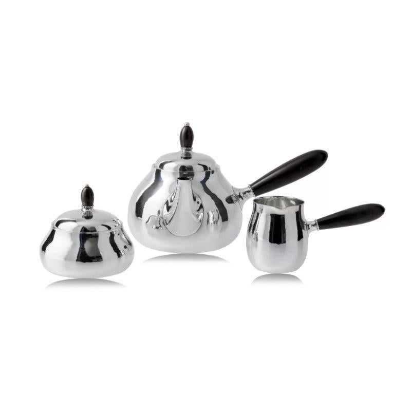 A Georg Jensen sterling silver tea service, design #80 by Georg Jensen from circa 1915. Simple elegant design, the only decoration is a beaded edge under the finials and the hand-hammered surface of the silver.
The set includes –Teapot, Cream Jug,