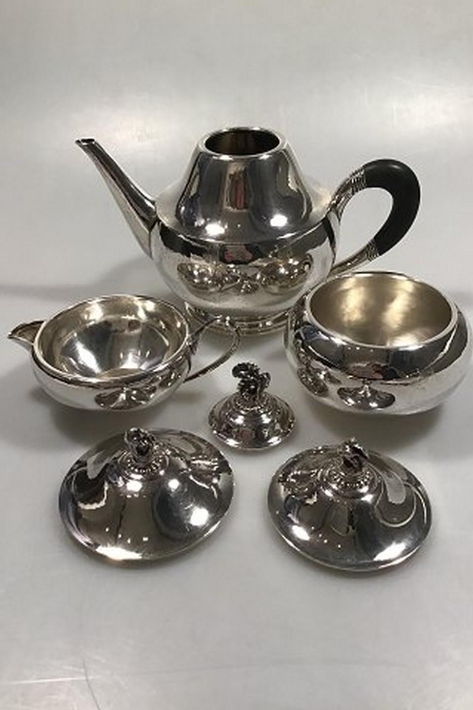 Georg Jensen sterling silver tea set no. 322, (1915-1933). Measures:
Tea pot H 17 cm (6 11/16 in) weight 500 gr/17.60 oz
Creamer H 8.5 cm (3 11/32 in) weight 194 gr/6.85 oz
Sugar bowl H 10.5 cm (4 9/64 in) weight 239 gr'78.45 oz (small