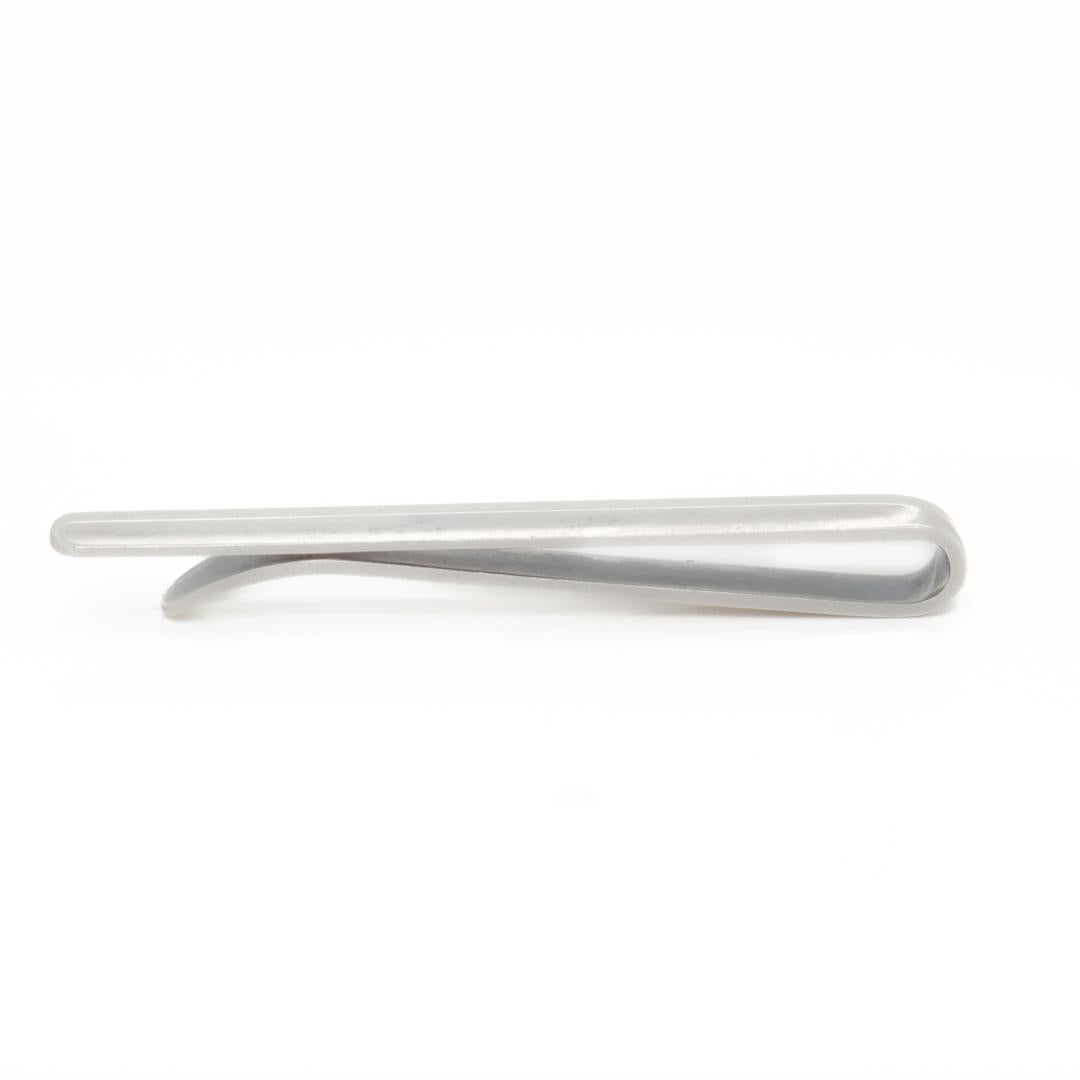 A fine Georg Jensen tie bar.

In sterling silver.

Model no. 82.

Designed by Flemming Eskildsen for Georg Jensen. 

Simply a wonderful tie clip from one of Denmark's premier silversmiths!

Date:
20th Century

Overall Condition:
It is in overall