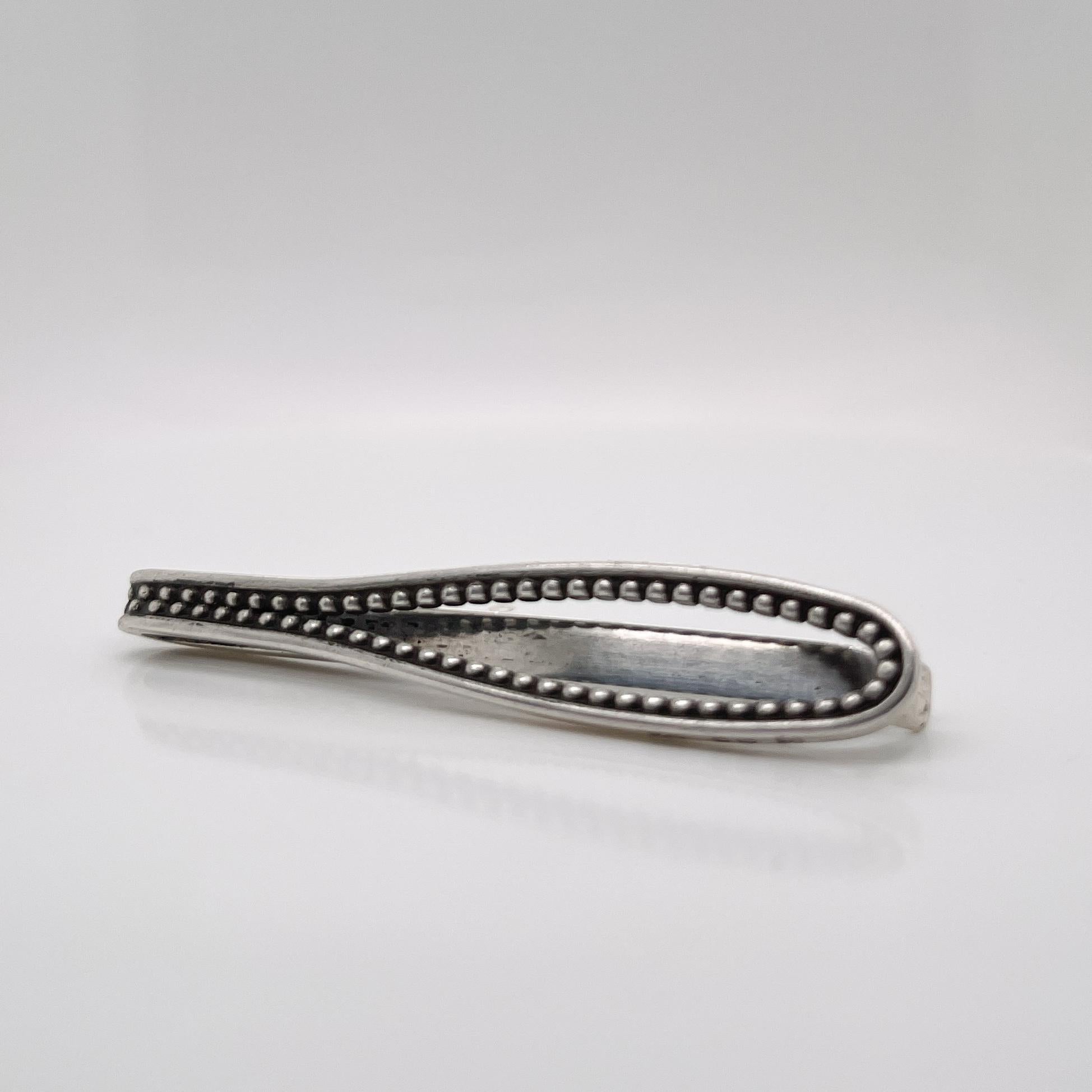 A very fine Georg Jensen sterling silver tie bar or money clip.

With an oval 