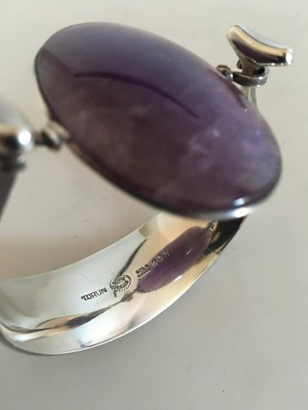 Georg Jensen Sterling Silver Torun Armring with Amethyst No 203. The Bangle has a diameter of about 6 cm / 2 23/64 in. Weighs 55 g / 1.95 oz.