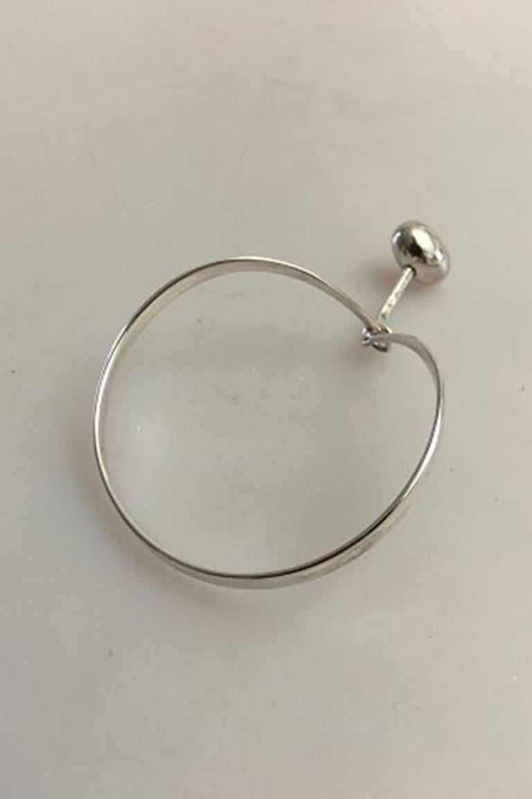 Georg Jensen Sterling Silver Torun Bracelet #205 with Pendant #303. From after 1945.

Weighs 20 g / 0.75 oz. Measures 7.5 cm x 6 cm dia (2 61/64 in. x 2 23/64 in.). Pendant is 3.5 cm L (1 3/8