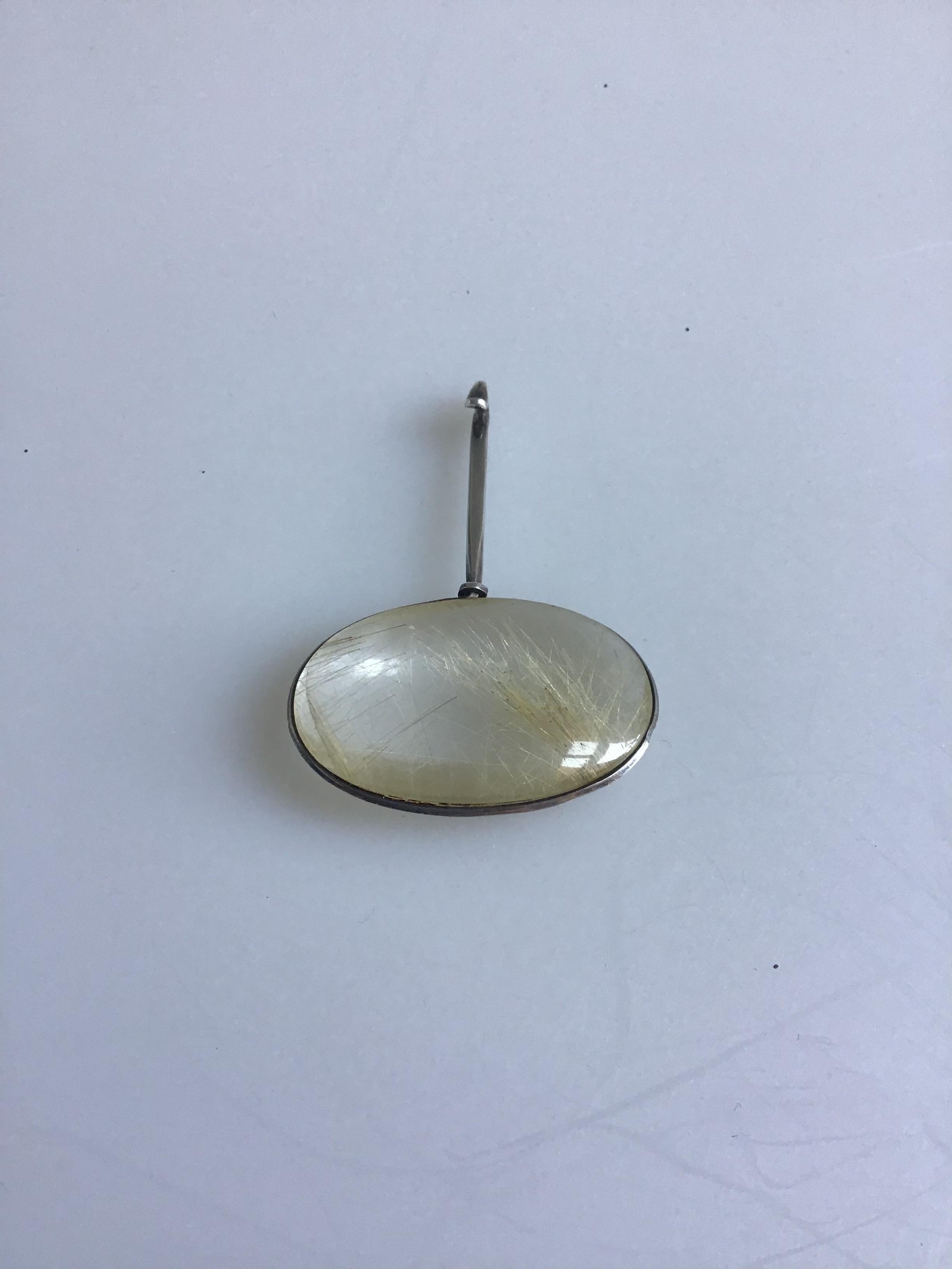 Georg Jensen Sterling Silver Torun Rutile Quartz Pendant #133. Designed by Vivianna Torun Bülow-Hübe. Pendant measures 2.6 x 1.8 x 0.4 inch/6.7 x 4.5 x 1 cm. Weight is 21,5 g / 0,76 oz Back of stone has hairline