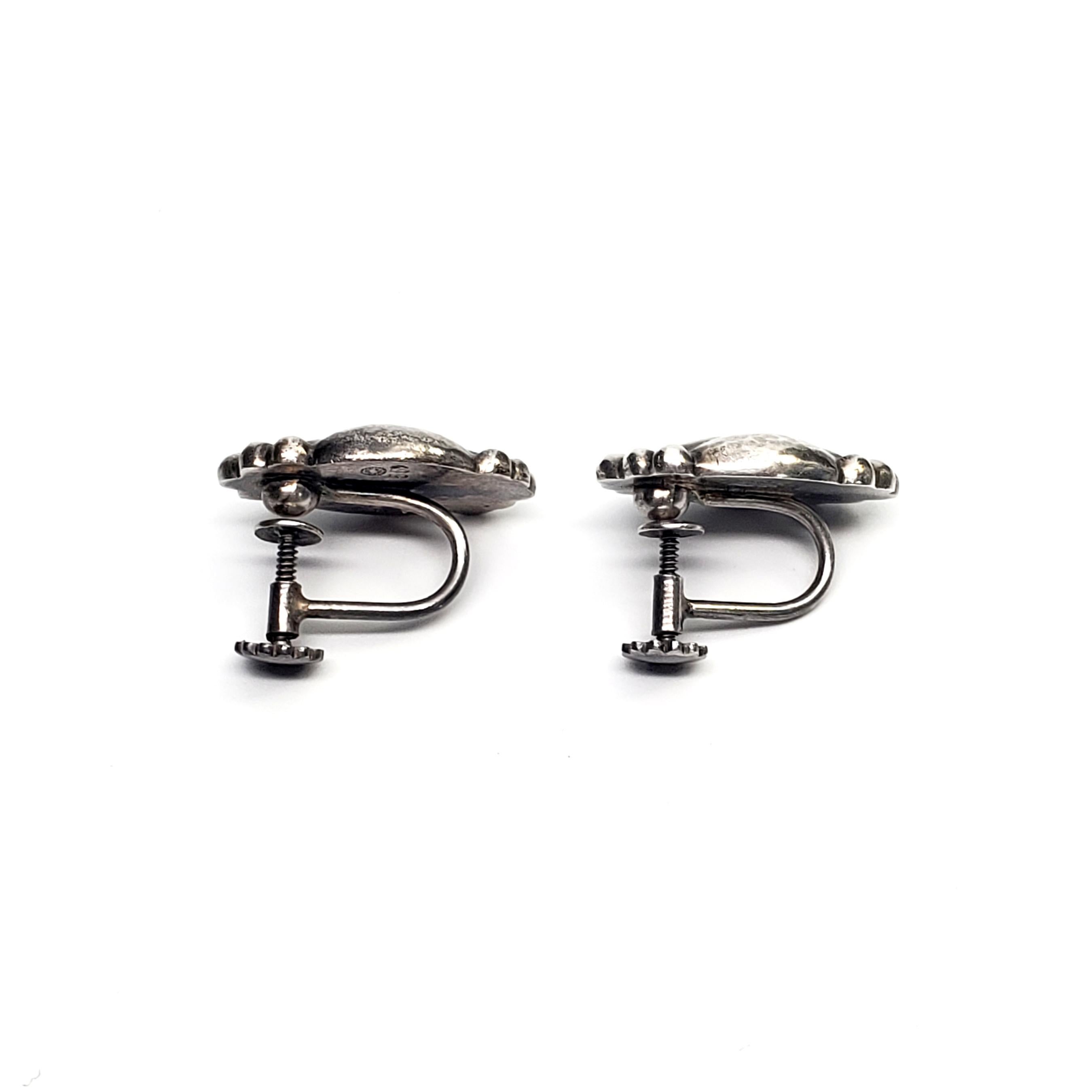 Vintage Georg Jensen sterling silver Moonlight Blossom #55 screw back earrings.

The Moonlight Blossom pattern was designed by Georg Jensen himself, inspired by nature motifs, as is typical of Georg Jensen's work. These beautiful earrings feature a