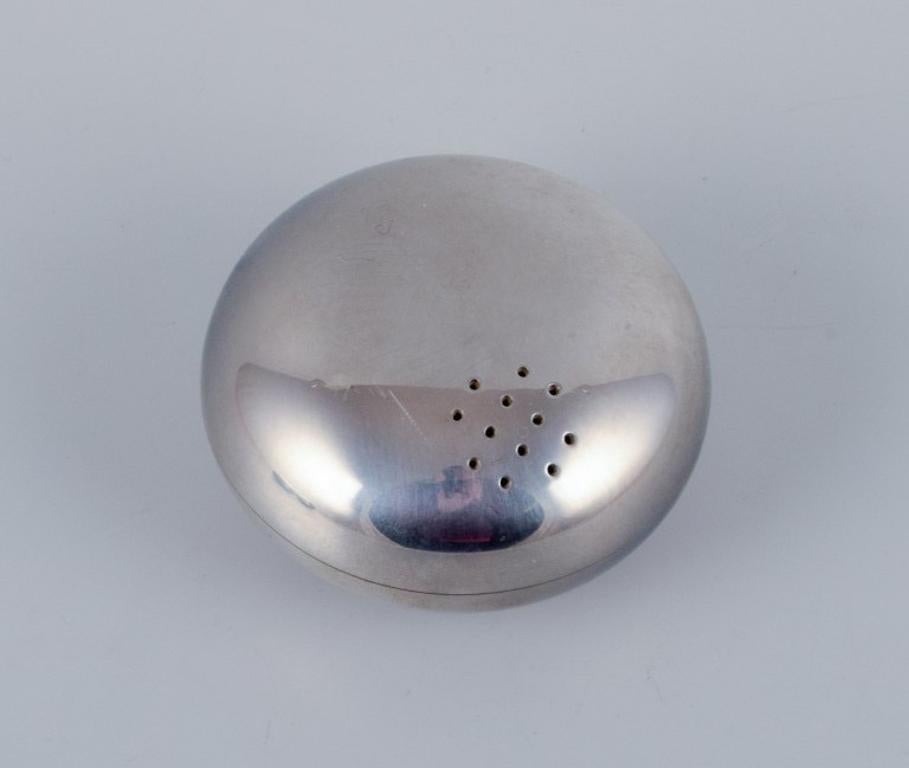 Georg Jensen, three pieces in stainless steel. 
Salt and pepper shakers and ashtray.
In stylish Danish design.
1980s.
In excellent condition.
Marked.
Dimensions: D 6.5 cm x H 3.0 cm.