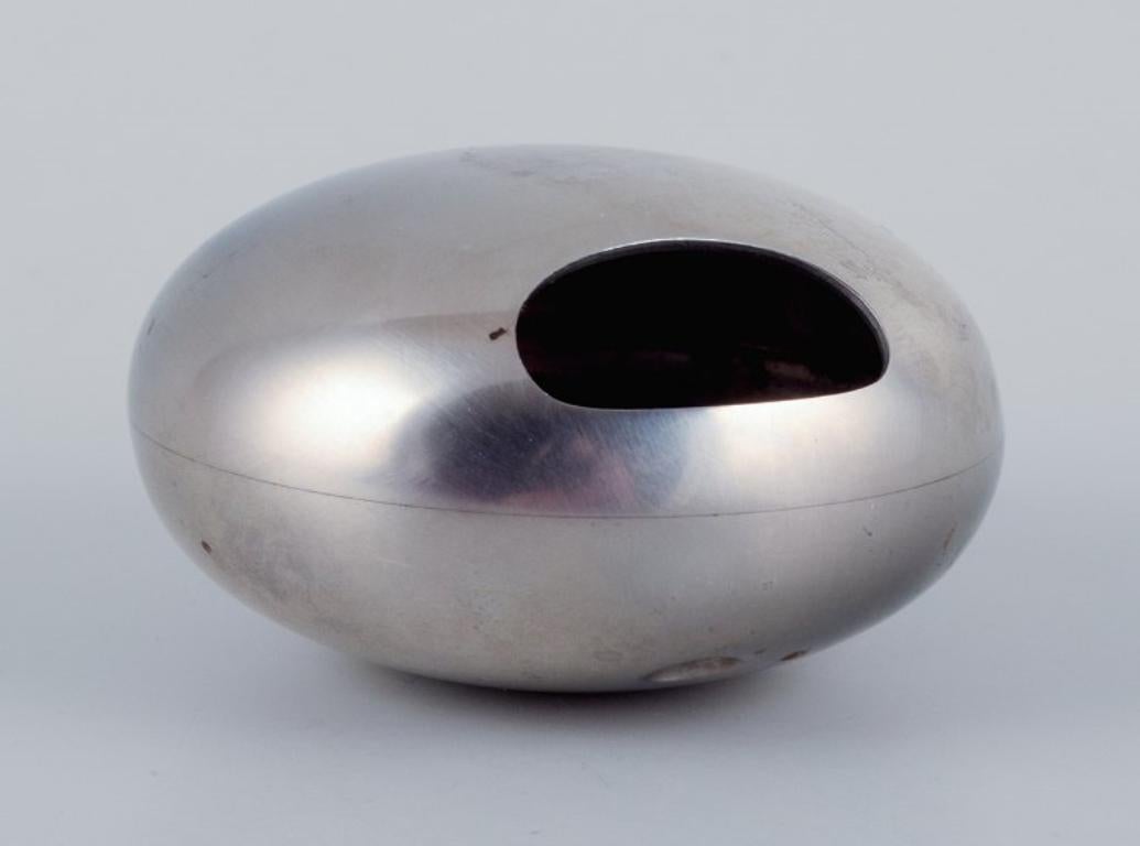Scandinavian Modern Georg Jensen, three pieces in stainless steel. Salt & pepper shakers, ashtray.
