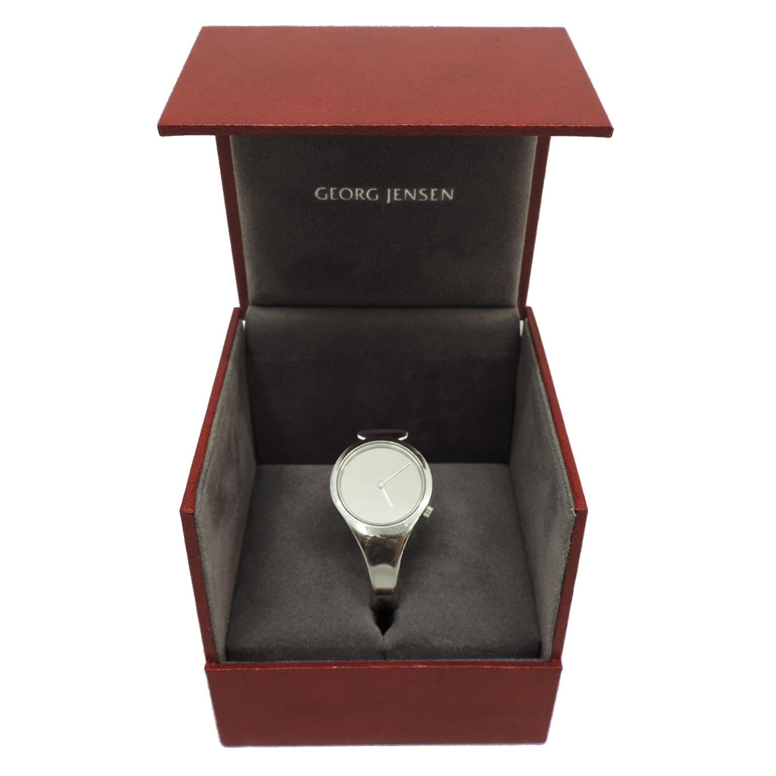For lovers of good design this wristwatch designed by Vivianna Torun is a timeless classic. Originally designed in 1969. Numberless, strapless, mirrored, its complete lack of distracting adornments is a departure from usual watch designs. 

The