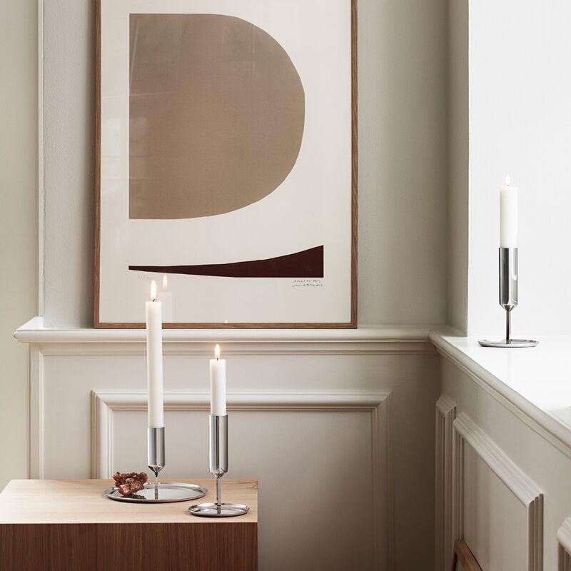 Pure Scandinavian minimalism at its very best, this tall stainless steel candleholder strips back all detail to revel in the simplicity of shape and material. The mirror-polished surface reflects back the candle light from the wide base giving an