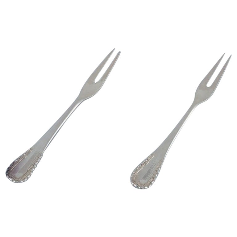 Georg Jensen, Viking, two cold meat forks/herring forks in 830 silver.