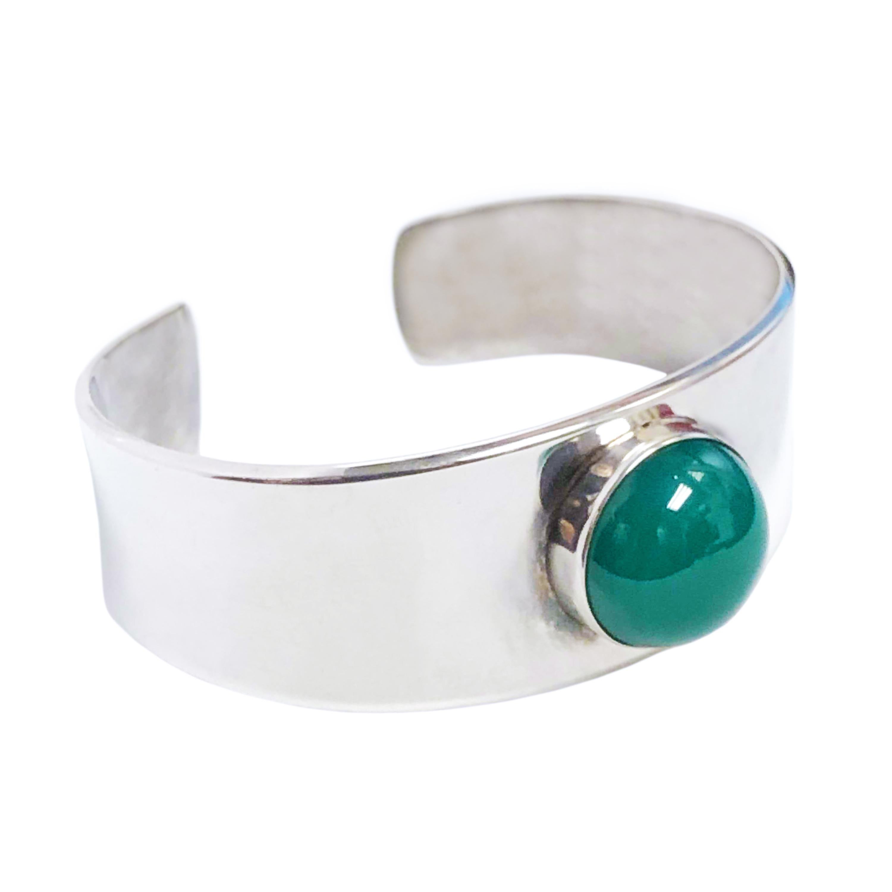Circa 1960s Georg Jensen Denmark Sterling Cuff Bracelet design by Poul Hansen, measuring 7/8 inch wide at the top and tapering down to 5/8 inch. Centrally set with a Green Chryophrase measuring 16 MM in diameter. Inside measurement is 6 1/2 inches