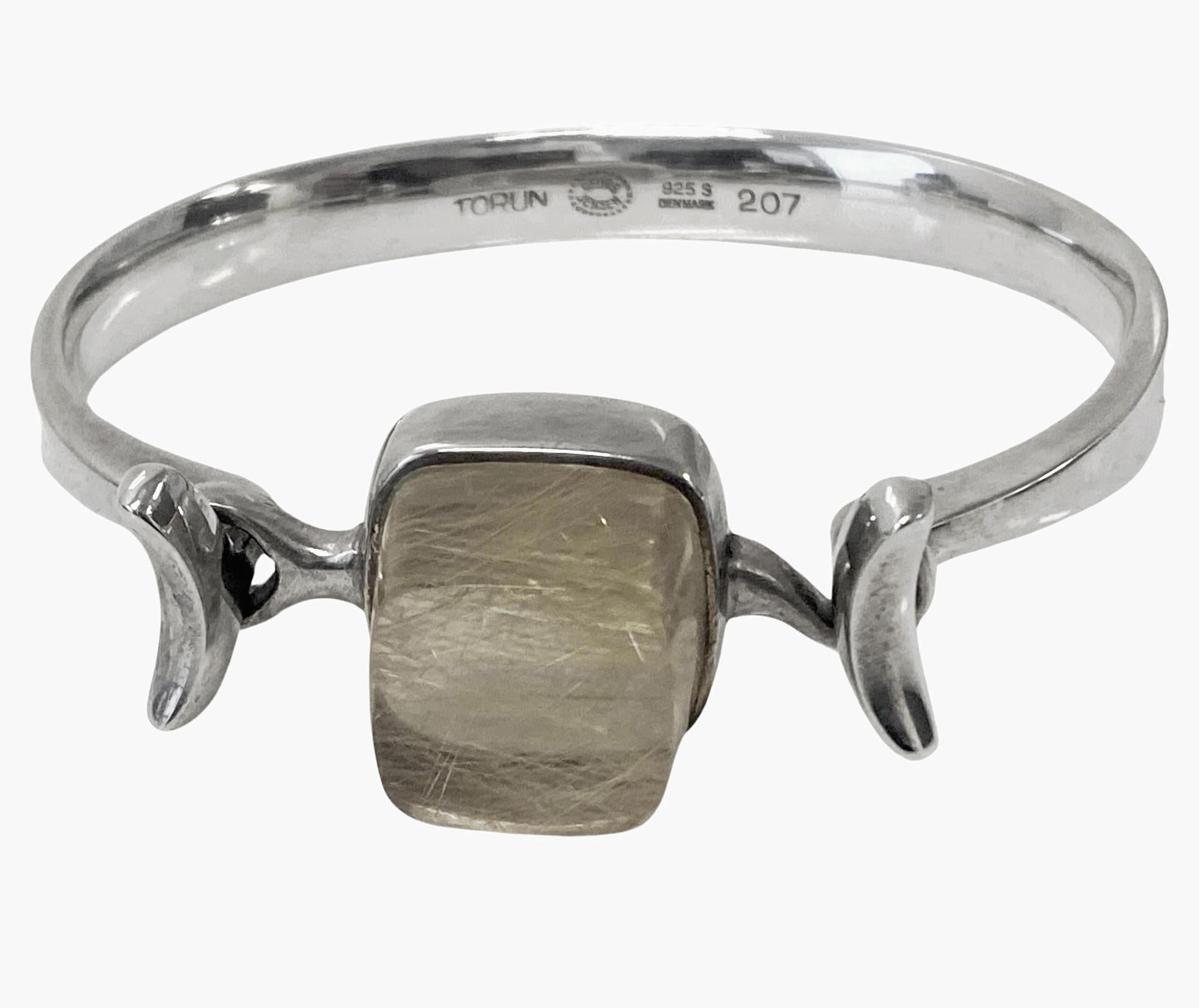 Georg Jensen Bangle rutilated quartz # 207. Designed by Vivianna Torun Bülow-Hübe C.1967. Sterling Silver rare design. Fits wrists up to 7 inches, tension clamp opening. Approximate dimensions: bangle circumference inside: 17.00 cm (6.7 inches)