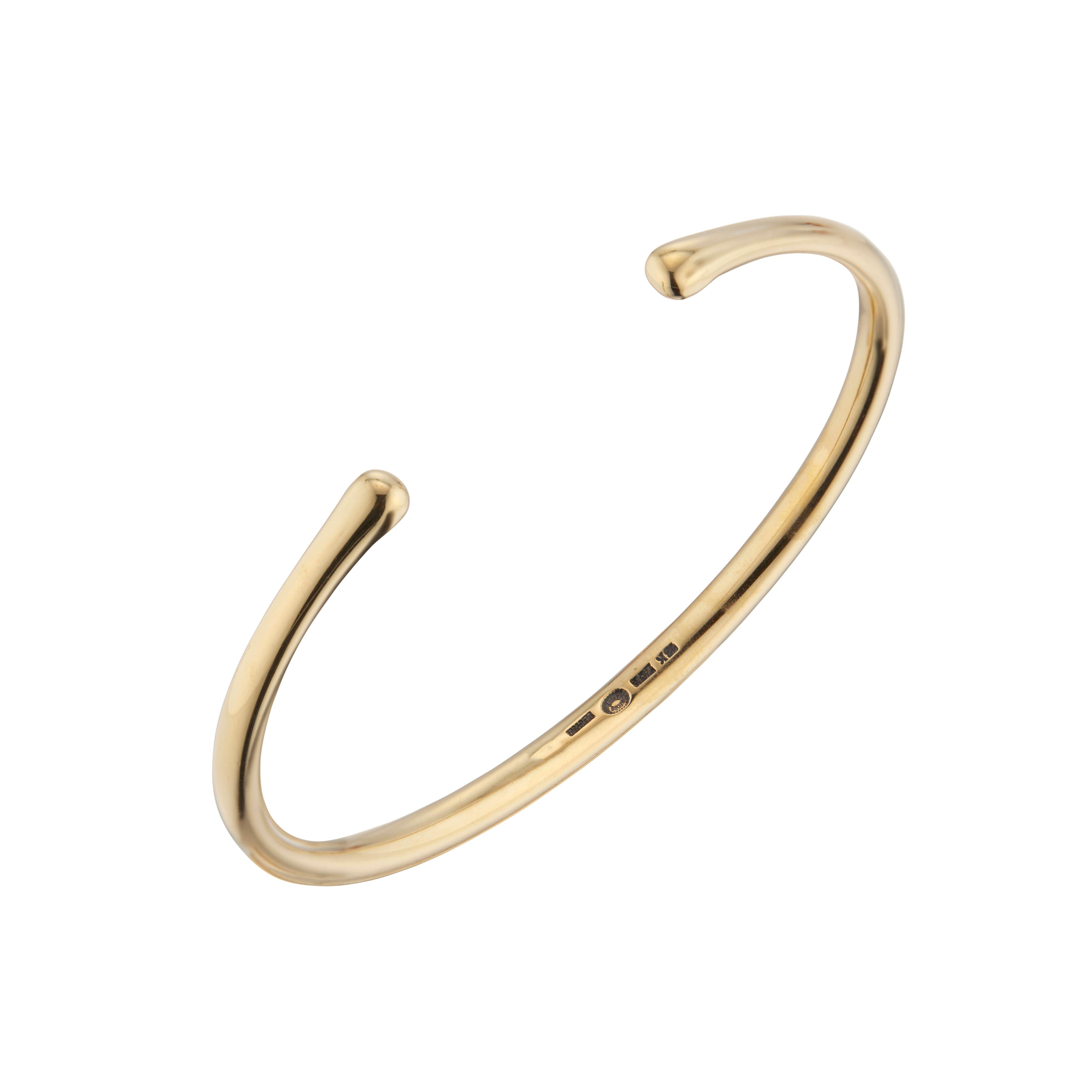 Georg Jensen 18k yellow gold cuff style bracelet that tapers from center to ends.

18k yellow gold 
Stamped: 18k 750
Hallmark: Georg Jensen
29.2 grams
Width: 4.3mm at top
Inside dimensions: 2.45 Inches x 2.1 Inches
Thickness/depth: 4.1mm
Shape: Oval