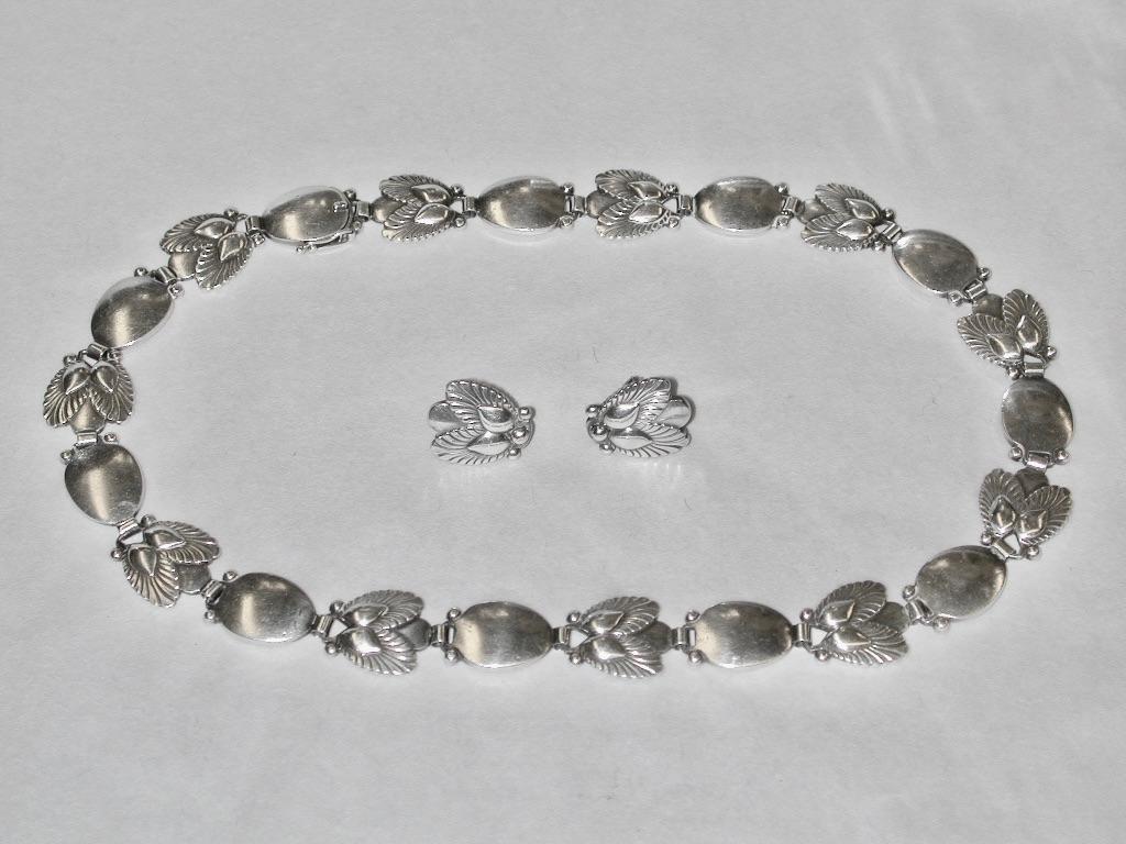  A sterling silver 'Bittersweet' #94B, designed by Gundorph Albertus (1887-1970) for Georg Jensen.
This beautiful necklace is 16.5 inches long with the snap fastened, and has an import hallmark for London for 1959.
The  matching sterling silver