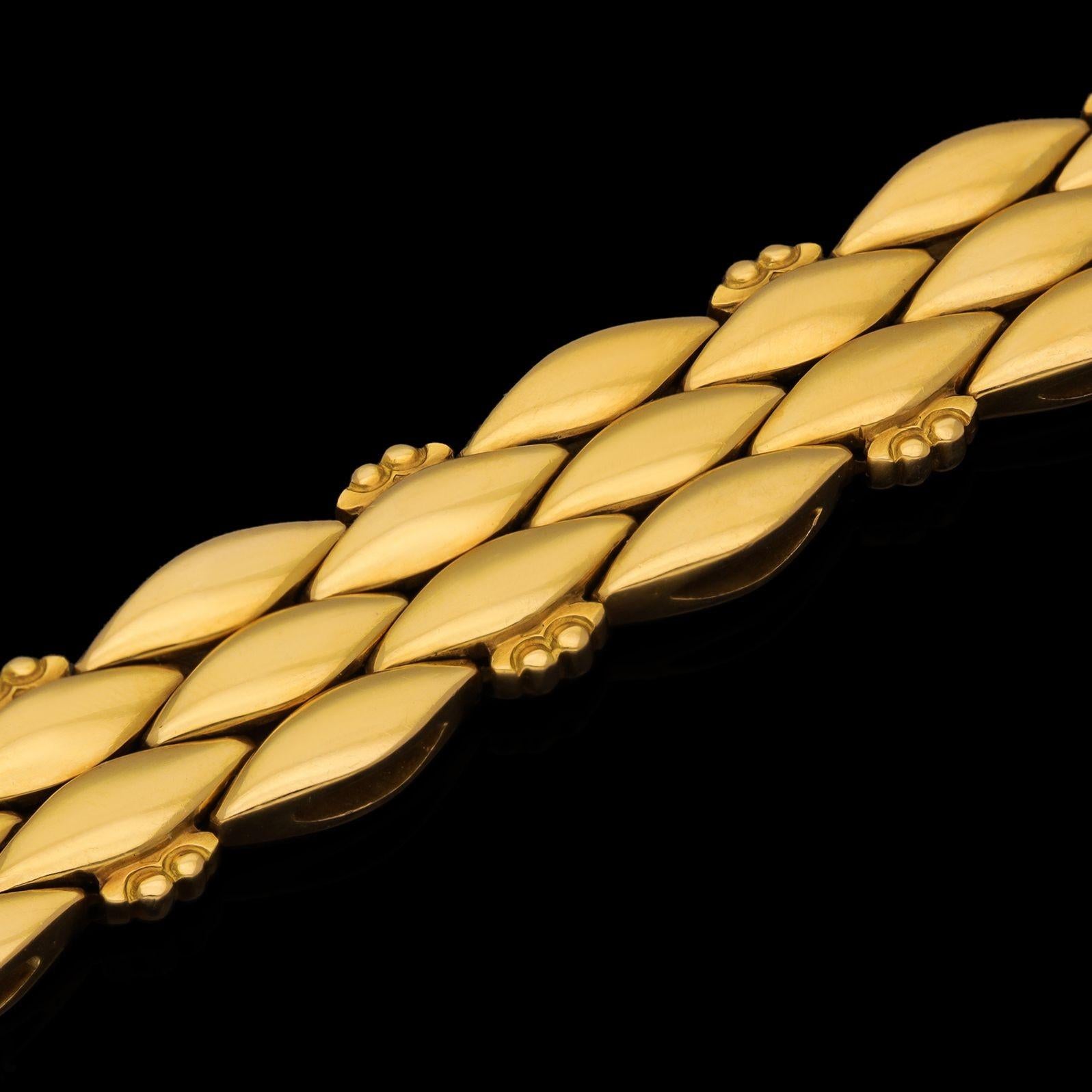 Description
An elegant 18ct gold vintage bracelet by Georg Jensen 1963, formed of three rows of double-sided domed navette shaped links running horizontally along the length of the bracelet, every alternate outer link is embellished with a little