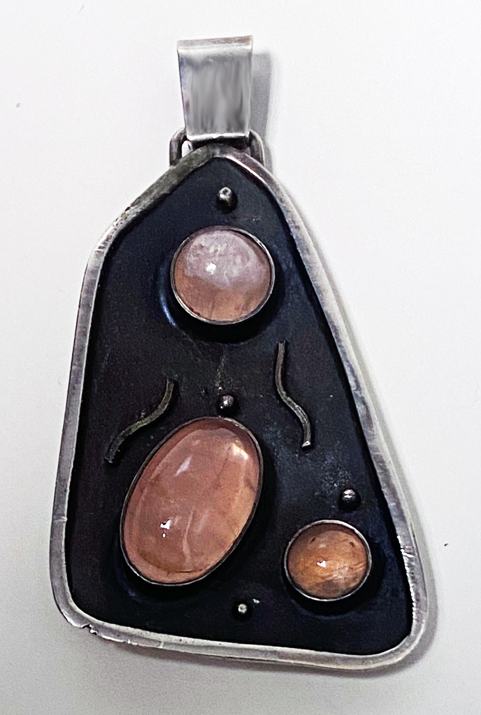 Georg Kramer modernist Silver and Rose Quartz Pendant Germany C. 1930. Asymmetrical form, handmade oxidised and polished silver bezel set with oval and round cabochon rose tint quartz. Pendant measures approximately 2.25 inches (height) x 1.25 width