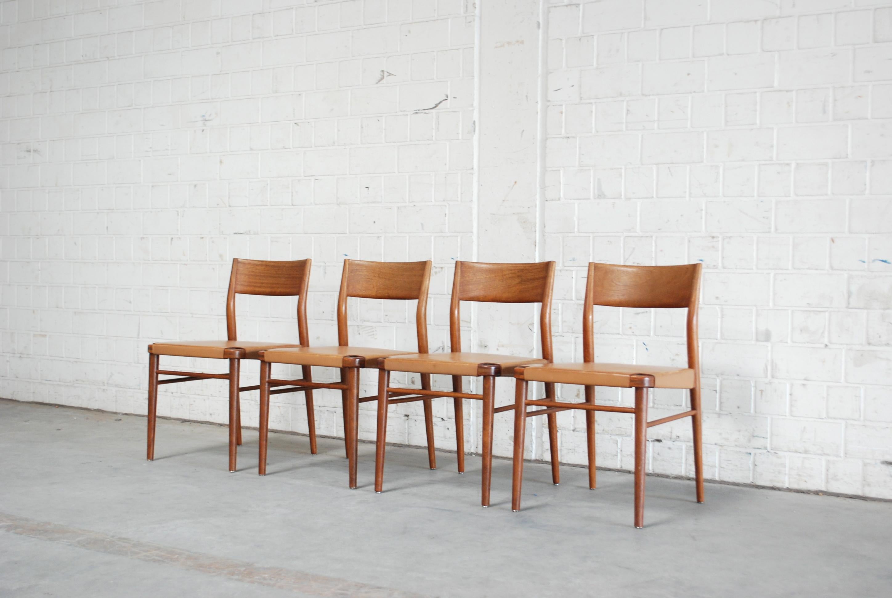 Wilkhahn dining chairs in caramel saddle leather designed by Georg Leowald.
The chairs have some patina.
Solid afromosia wood frame with nice details.
Set of 4.