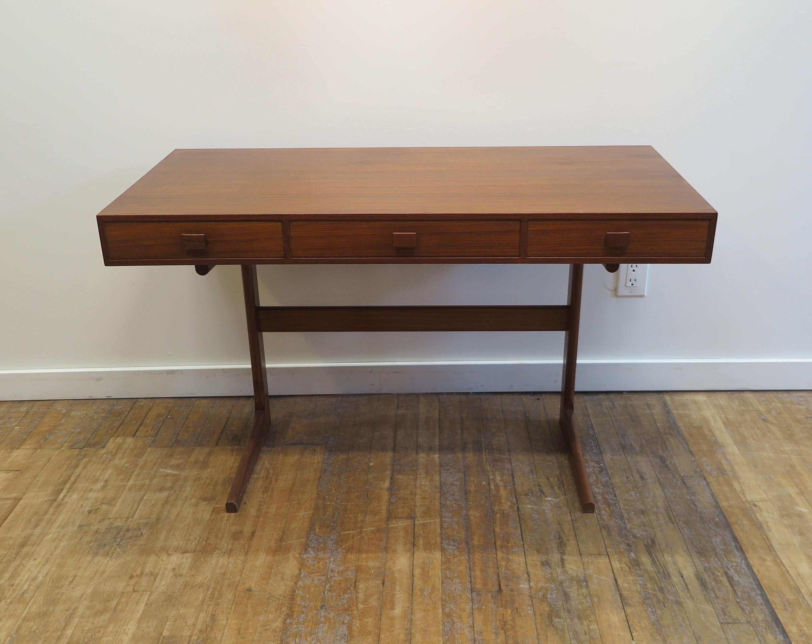 Danish Modern Cantilever Desk by Georg Petersens Molbelfabrik .  Georg Petersens Cantilever desk in teak.  The desk sits on two cantilever style legs with a slim case housing three drawers.  Stunning minimalist design completely functional.  This