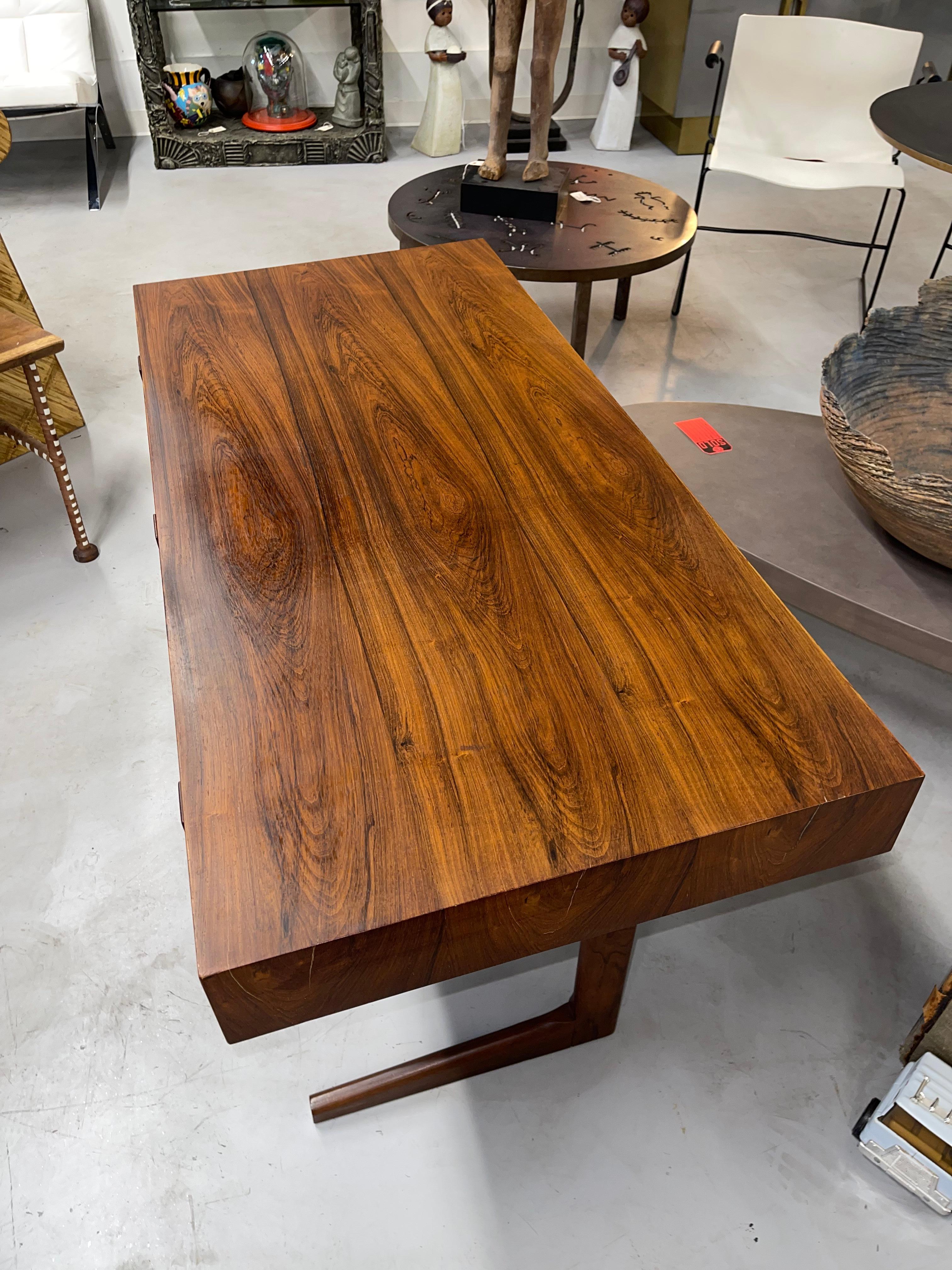 A stunning 1960’s Rosewood desk by Georg Petersen’s of Denmark. Nice vintage condition with beautiful graining to the rosewood. The front of the desk is 1/2 lower than than rear. Some wear to the veneer and age and use marks. Interior of the drawers