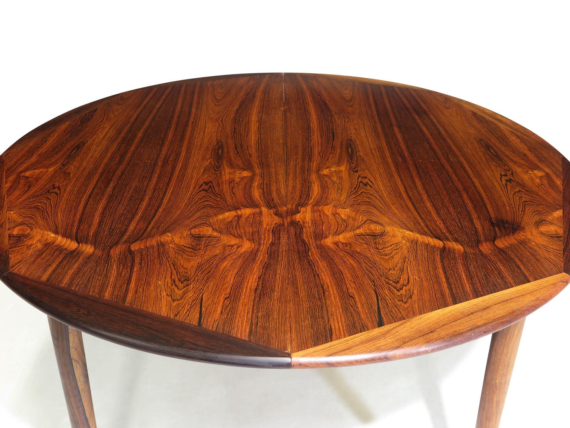Mid-century Danish round dining table by Georg Petersens Mobelfabrik, 1963, Denmark. The table is crafted from stunning book-matched Brazilian rosewood with beautiful dynamic grain patters, and solid octagonal edge. The table comes with one center