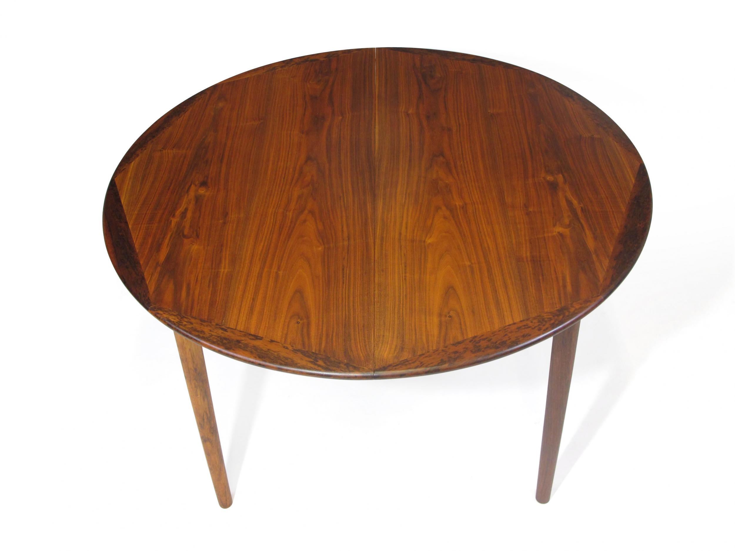 Round walnut dining table by Georg Petersens, circa 1960 Denmark. The table is crafted of walnut with solid walnut hexagon edge with one leaf. Finely restored by our in-house craftsman team, excellent condition with minor signs of age and use. Table