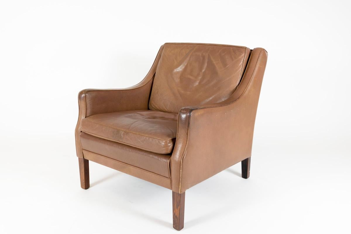 A sophisticated lounge chair by Georg Thams, low back armchair covered in lovely tabak colored leather on a base finished with teak legs. The build quality is excellent and the leather is healthy with feather and down filled squabs which are