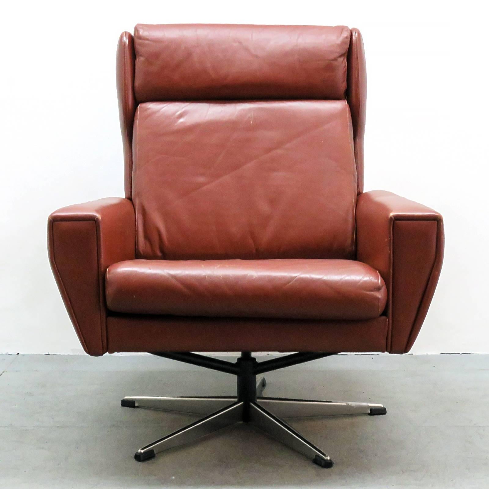 Wonderful Georg Thams for Lystager Industri A/S wing back lounge chair in cognac leather and chrome-plated aluminum.