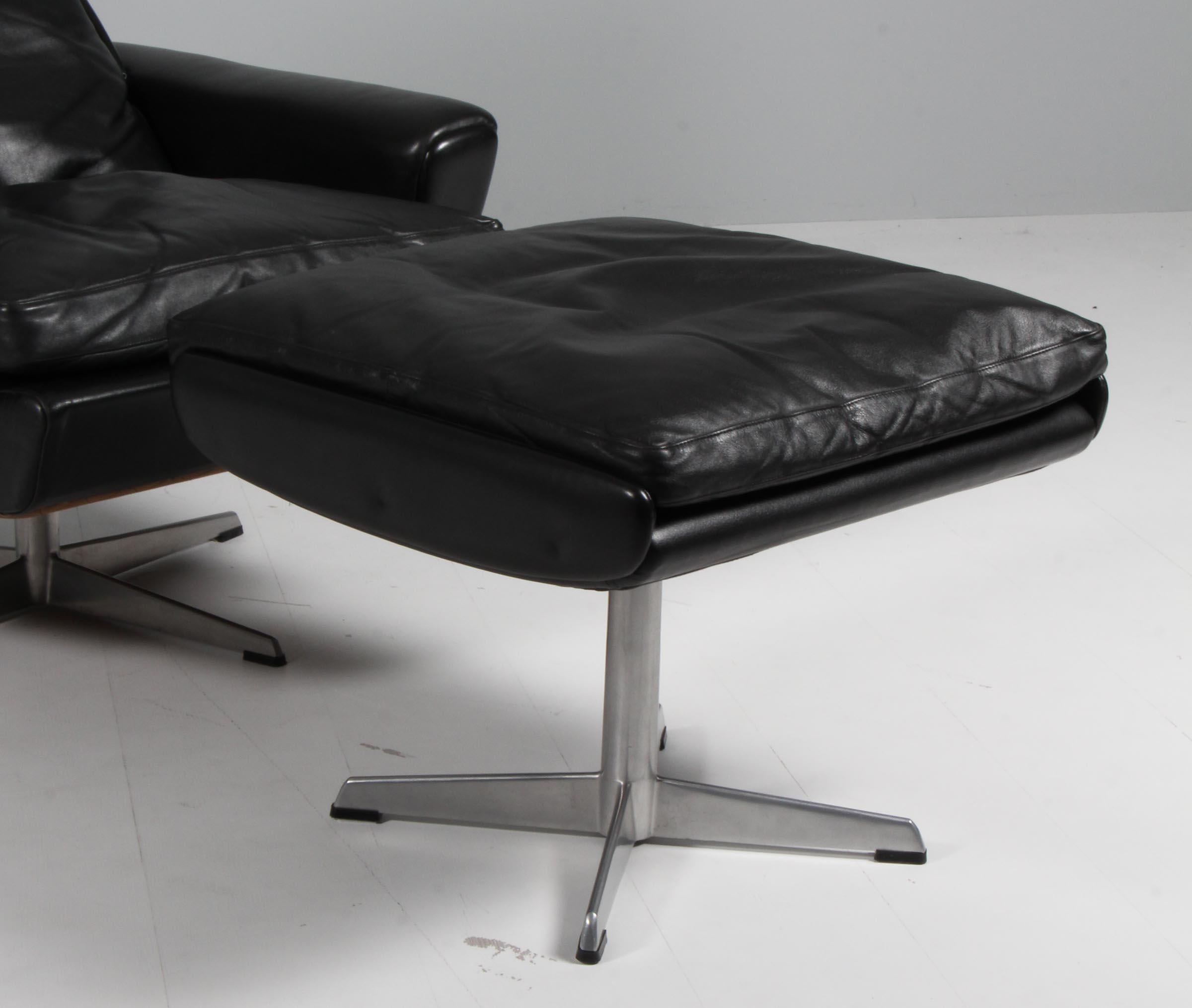 Danish Georg Thams swivel lounge chair with ottoman, original black leather.