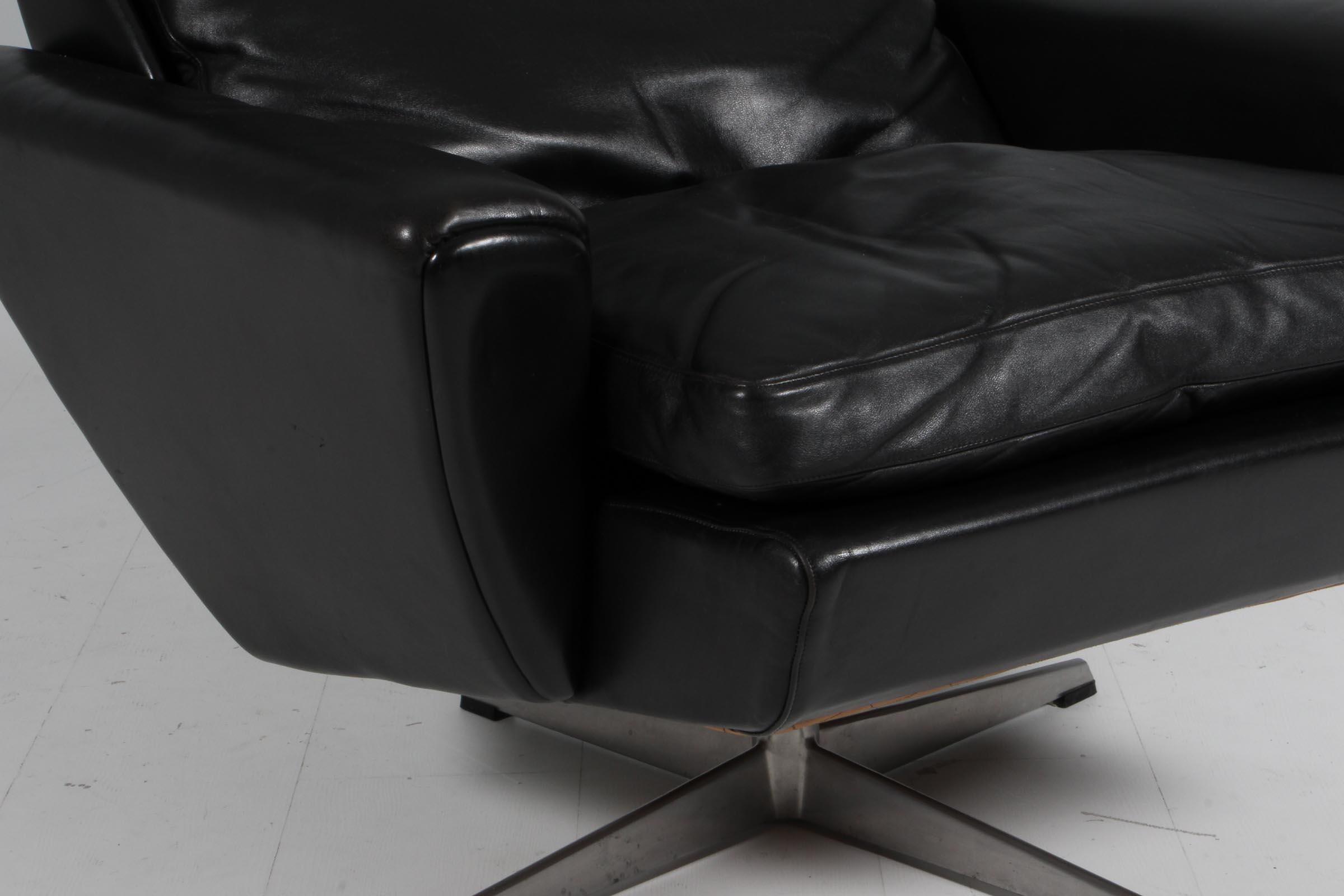 Leather Georg Thams swivel lounge chair with ottoman, original black leather.
