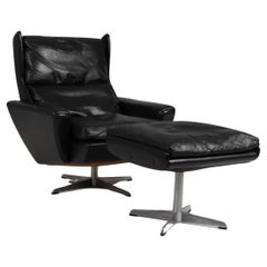 Retro Georg Thams swivel lounge chair with ottoman, original black leather.