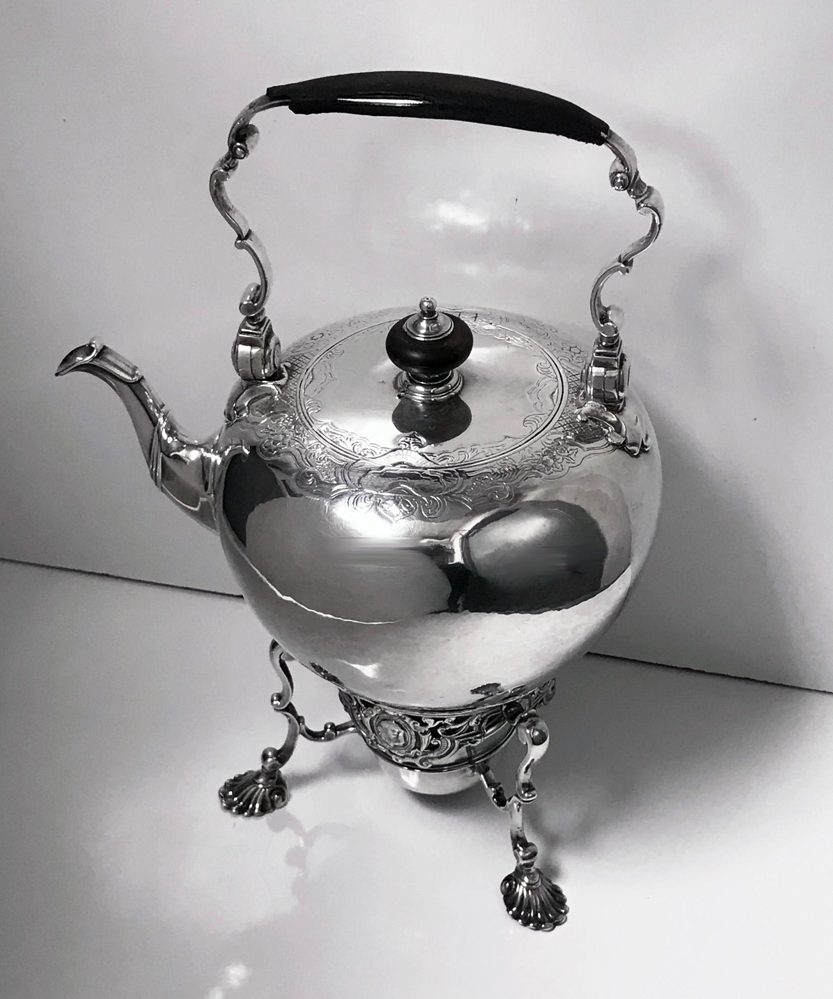 George 11 silver Kettle on stand, London 1736 Richard Gurney and Thomas Cook. Large bullet shape Kettle with flat chased decorative border on tri form on shell knuckle support stand, pierced frieze with face masks surround with burner, leather clad