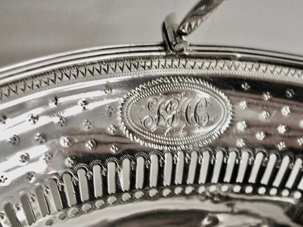 George 111 bright cut silver sweet basket, henry chawner, London Assay, 1789.
Lovely bright cut engraving with hand saw cut piercing.
This exquisite piece is made just like a miniature cake basket of the same period, the readed handle is