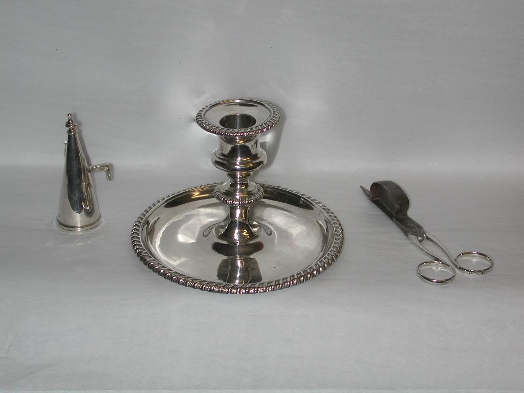 George 111 Silver Chamberstick with Wick Trimmers and Extinguising Cone, 1812
The matching wick trimmers are made in steel and silver, and the cone is silver.
This exquisite chamber-stick was assayed in Sheffield in 1812, and made by the