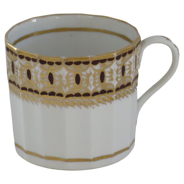 This is a good, early hand-painted English coffee can, from the late George-III period, of the late 18th Century, circa 1795, which we attribute to New Hall.

This hard paste coffee can is nominally straight sided with a plain loop handle, the