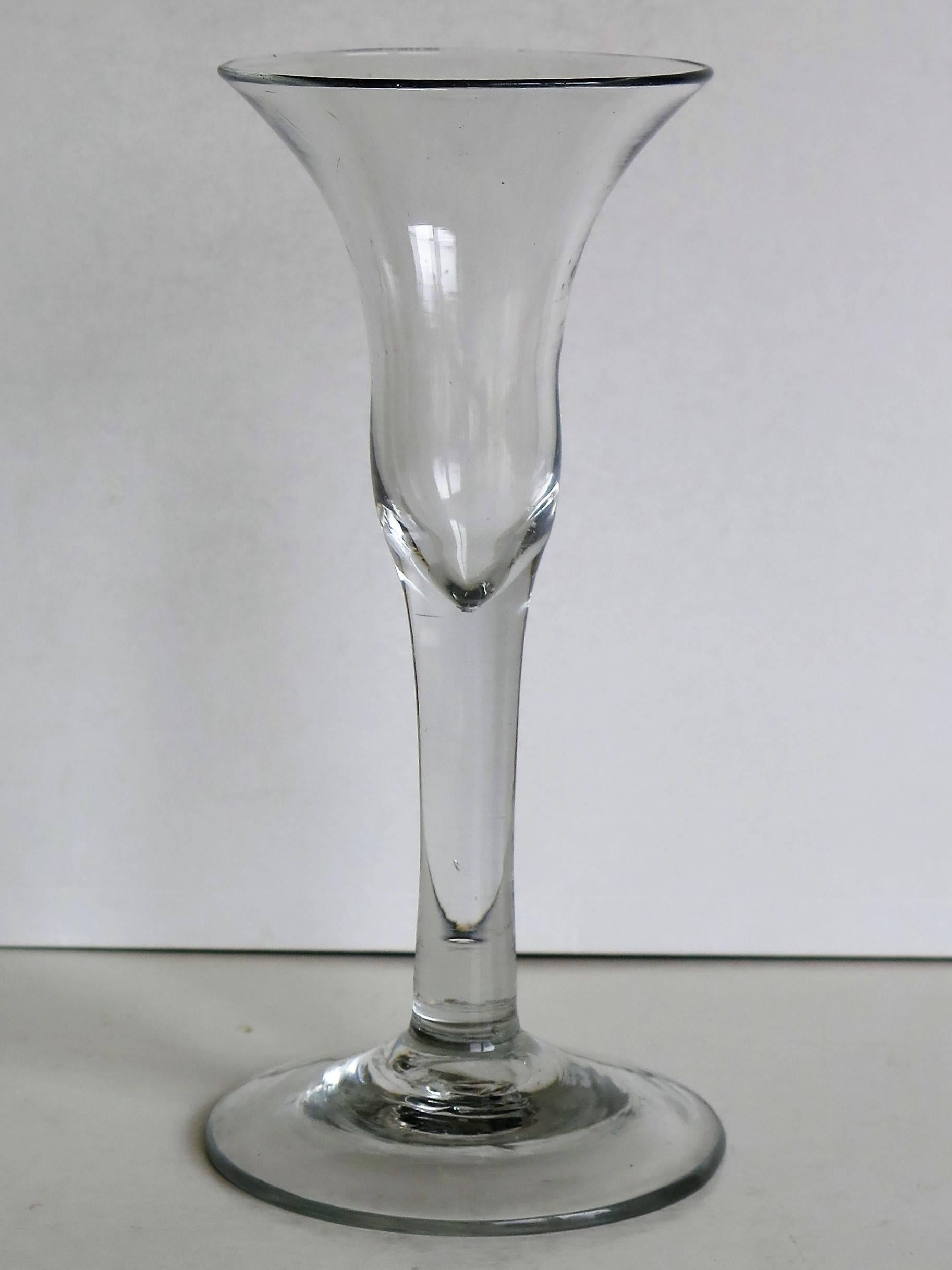 This is a very good, tall, English, mid-Georgian, handblown, wine drinking glass, dating to the George II period of the mid-18th century, circa 1740.

These glasses are very collectable.

This wine glass is hand-blown from English lead glass. It is