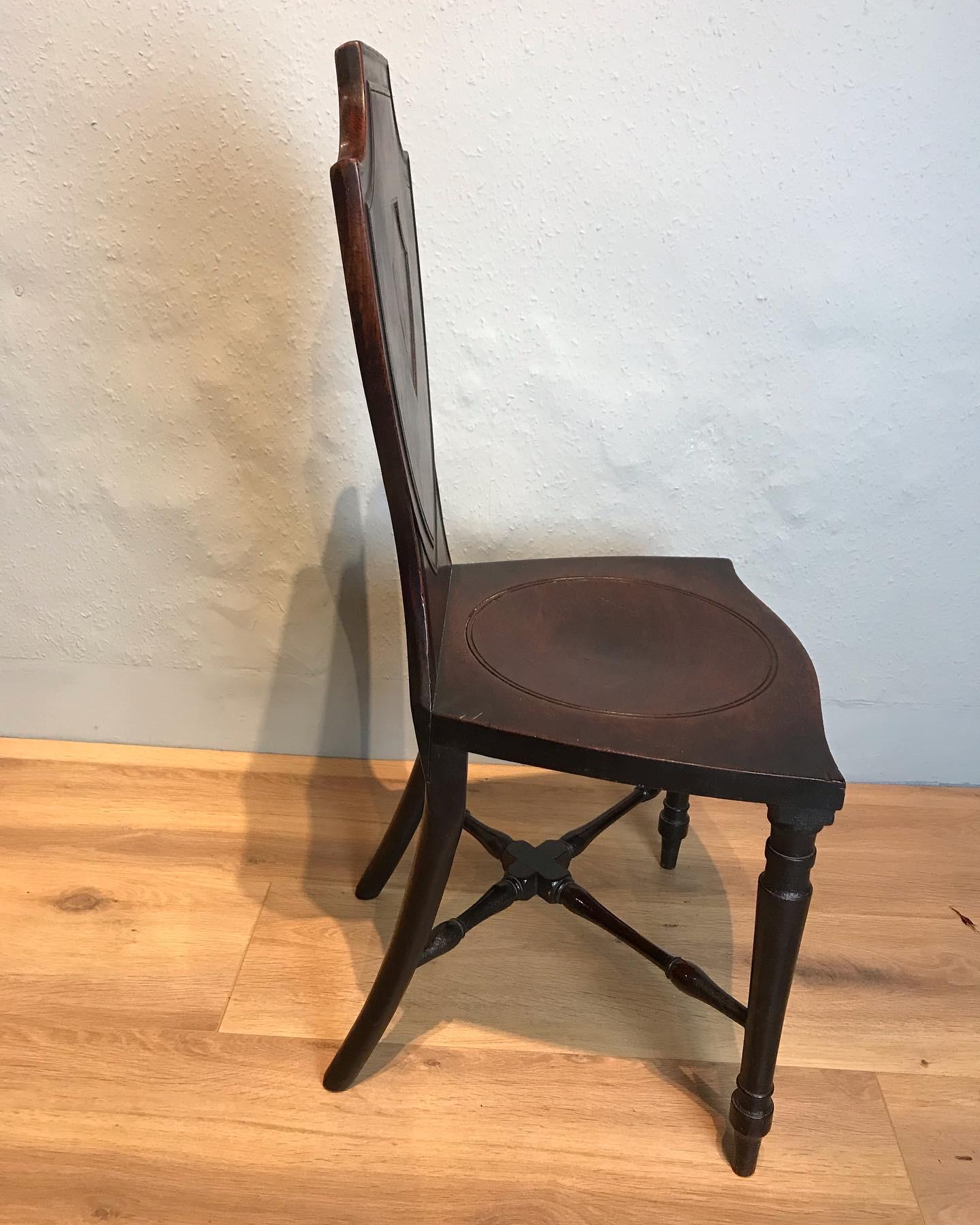 Sheraton period mahogany shield back hall chair circa 1780 with circular dished seat resting on elegant turned legs with lower stretcher, wonderful untouched condition, no breaks with a lovely patina.